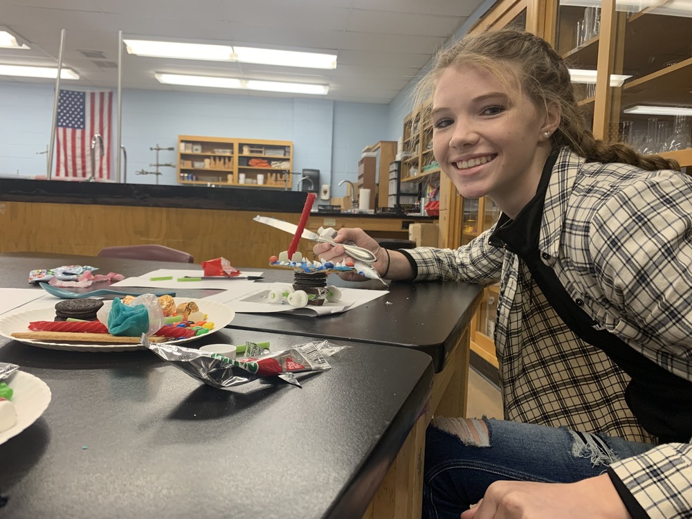 Female Student showing off candy Mars Rover