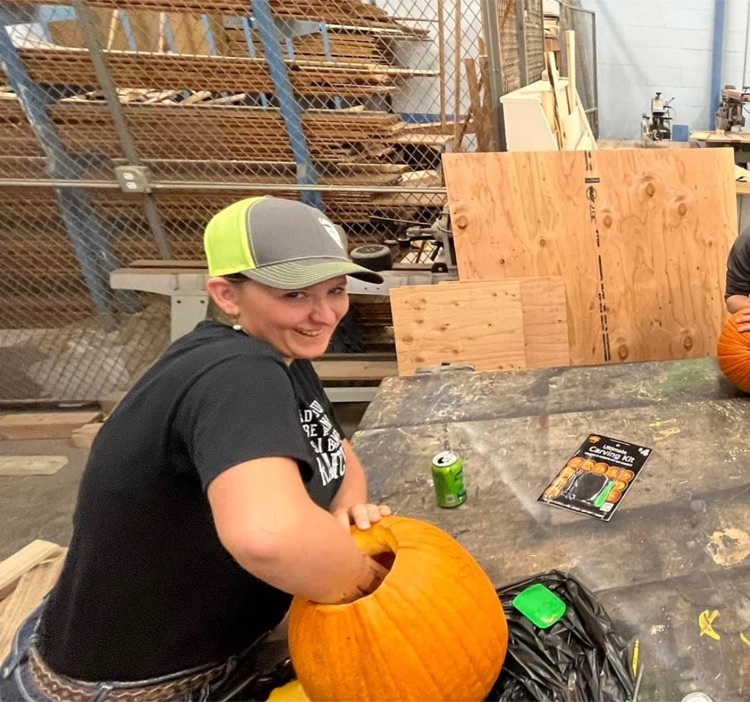 student carving a pumpkin 
